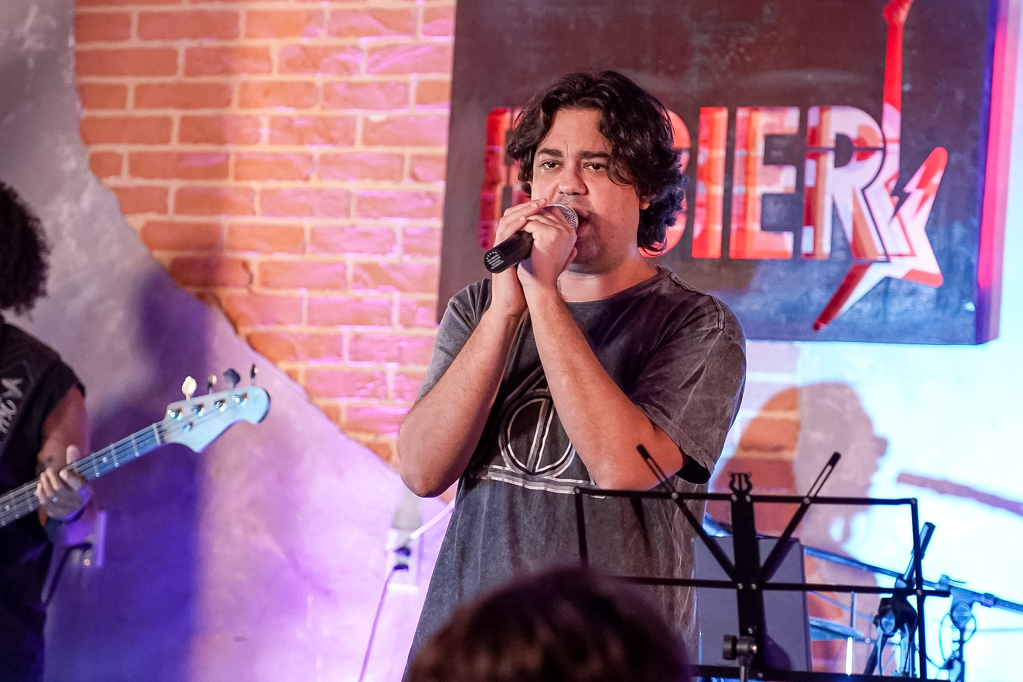Aluno cantando em apresentação da Ponto Musical
